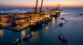 Busy Shipping Port at Dusk with Container Ship, Cranes, and Tugboats in Water harbor cargo ship Royalty Free Stock Photo
