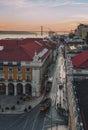 Aerial view of a bustling street with trams in Lisbon at sunset. Portugal.