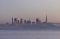 A city skyline with skyscrapers and a boat in the water Royalty Free Stock Photo