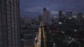 Aerial view of busy multilane street in night city. Rising shot revealing evening cityscape. Manila, Philippines