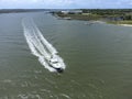 Aerial view of cabin cruiser boat moving along the coast of South Carolina