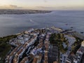 Aerial view of Cacilhas small township at sunset along the Tagus river with Lisbon city center in background, Almada, Portugal Royalty Free Stock Photo