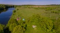 Aerial view of camp of tourists with tents on the river bank.