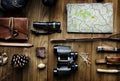 Aerial view of camping equipments and map on wooden table