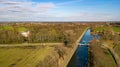 Canal Through Countryside with Distant Town