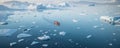 aerial view of canoe floating in calm clear water with icebergs in Greenland in daylight Royalty Free Stock Photo