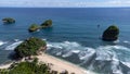 Aerial view of Goa Cina beach with white sand and big waves in Indonesia