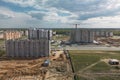 An aerial view captures a sprawling, tall building under construction, with cranes lifting materials and workers buzzing around Royalty Free Stock Photo