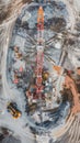 An aerial view capturing the intricate details of a massive drilling operation, with a towering orange rig surrounded by Royalty Free Stock Photo
