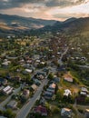 Aerial view capturing the serene beauty of a rural town as the sunset paints the landscape in soft, warm hues, with Royalty Free Stock Photo