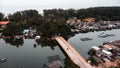 aerial view of car crossing small long bridge over river to island. Royalty Free Stock Photo