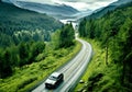 aerial view of the car driving of country road through green woods Royalty Free Stock Photo