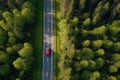 Aerial view of a car driving on the road in the forest, Aerial view of red car with a roof rack on a green summer forest country Royalty Free Stock Photo