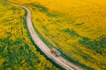 Aerial View Of Car SUV Parked Near Countryside Road In Spring Field Rural Landscape. Flowering Blooming Rapeseed Royalty Free Stock Photo