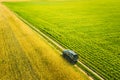 Aerial View Of Car SUV Parked Near Countryside Road In Spring Field Rural Landscape. Car Between Young Wheat And Corn Royalty Free Stock Photo