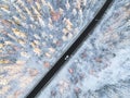 Aerial view of a car on winter road in the forest. Winter landscape countryside. Aerial photography of snowy forest with a car on Royalty Free Stock Photo