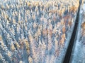 Aerial view of a car on winter road in the forest. Winter landscape countryside. Aerial photography of snowy forest with a car on Royalty Free Stock Photo