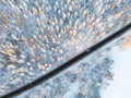 Aerial view of a car on winter road in the forest. Winter landscape countryside. Aerial photography of snowy forest with a car on Royalty Free Stock Photo