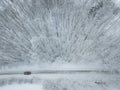 Aerial view of a car on winter road in the forest Royalty Free Stock Photo