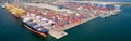 Aerial view of cargo ships loading containers at seaport. Royalty Free Stock Photo