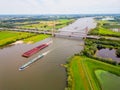 Aerial View on Cargo Ships sailing on the Waal River in The Netherlands