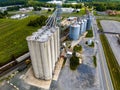 Aerial view of a cargo train by a farm with tall grain elevators and tanks in Delaware Royalty Free Stock Photo