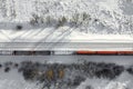 Aerial view of cargo train wagons, a double-track railway. Winter rail road with white snow, top view Royalty Free Stock Photo