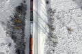 Aerial view of cargo train wagons, a double-track railway. Winter rail road with white snow, top view Royalty Free Stock Photo