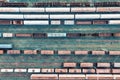 Aerial view of cargo trains. Railway wagons with goods on railroad. Top view of colorful freight train on the railway station. Royalty Free Stock Photo