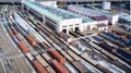 Aerial view of cargo trains. Railway wagons with goods on railroad. Top view of colorful freight train on the station