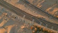 Aerial view cars driving along sandy trail path. Overhead desert offroad vehicle Royalty Free Stock Photo