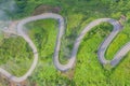 Aerial view of cars driving on curved, zigzag curve road or street on mountain hill with green natural forest trees in rural area Royalty Free Stock Photo