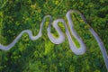 Aerial view of cars driving on curved, zigzag road or street on mountain hill with green natural forest trees in rural area of New