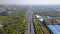 Aerial view of cars going straight to city on highway. Bridges or roads with natural green trees in structure of architecture and Royalty Free Stock Photo