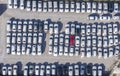 Aerial view cars for sale stock lot row, Car Dealer Inventory, parking lot. One red and all white Royalty Free Stock Photo