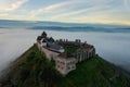 Aerial view about castle of Sumeg with foggy sunrise at the background.