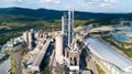 Aerial view of cement manufacturing plant. Concept of buildings at the factory, steel pipes, giants. Royalty Free Stock Photo