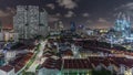 Aerial view of Chinatown with red roofs and Central Business District skyscrapers night timelapse, Singapore Royalty Free Stock Photo