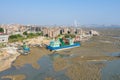 Aerial view of a Chinese traditional fishing village around Xiamen city, with residential buildings and fishing boats