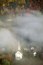 Aerial view of church steeple wreathed in morning fog in autumn, Waitsfield, VT Royalty Free Stock Photo