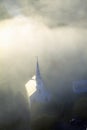Aerial view of church steeple wreathed in morning fog in autumn, Waitsfield, VT Royalty Free Stock Photo