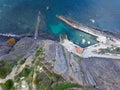 Aerial view of a ciff and a small pier with boats in transperant blue water Royalty Free Stock Photo