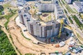 Aerial view of city construction site with high yellow industrial tower crane Royalty Free Stock Photo