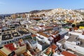 Aerial view of the city of Las Palmas, small white and brightly colored houses by the sea with blue sky and sunny day. Gran