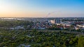 Aerial view of the city of rostock, railway tracks, river warnow and power plant chimney in the background