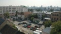 Aerial view of a city yard with ugly facades of houses and many parked cars. Stock footage. Parking located by the Royalty Free Stock Photo