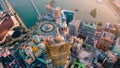 Aerial view of cityscape Dubai surrounded by buildings and water during sunset