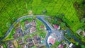 Aerial view of the Ciwidey tea plantation beside the street and village housing. West Java, Indonesia