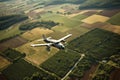 aerial view of classic airplane flying over rural landscape