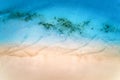 Aerial view of clear blue sea with waves and empty sandy beach Royalty Free Stock Photo